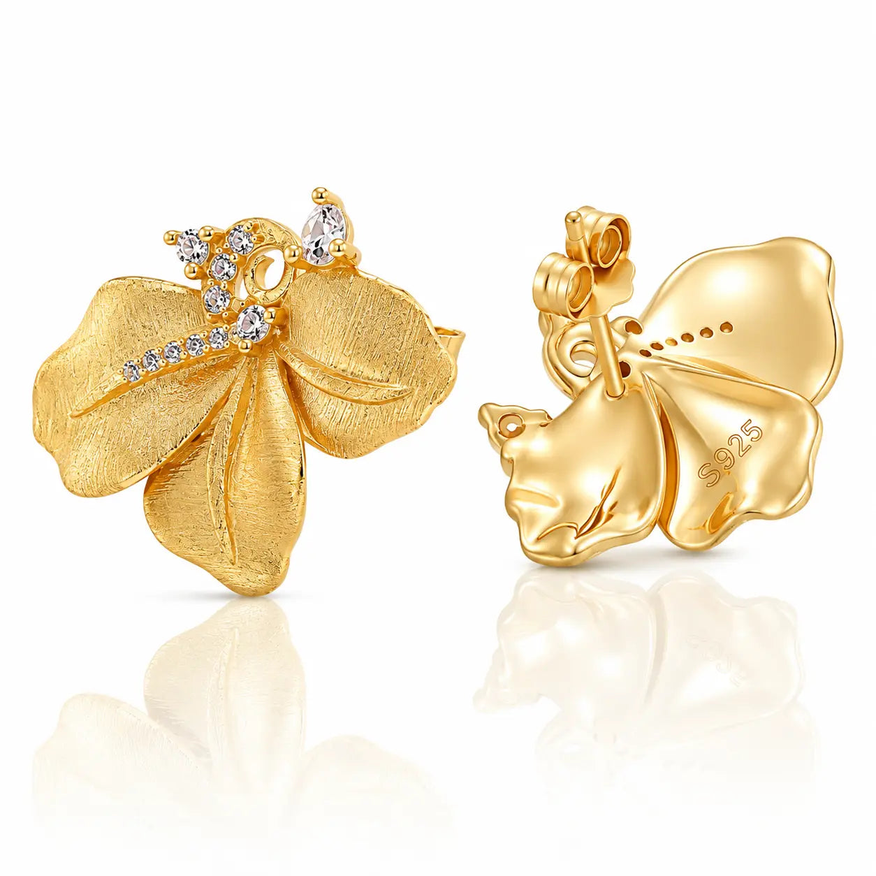 A pair of yellow gold flower-shaped earrings with clear gemstones, shown from both the front and back on a reflective white surface.