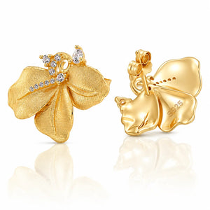 A pair of yellow gold flower-shaped earrings with clear gemstones, shown from both the front and back on a reflective white surface.
