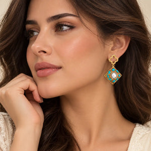 Woman wearing elegant earrings and rings against a natural background