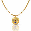 Gold necklace with a circular pendant featuring colorful stones on a white background