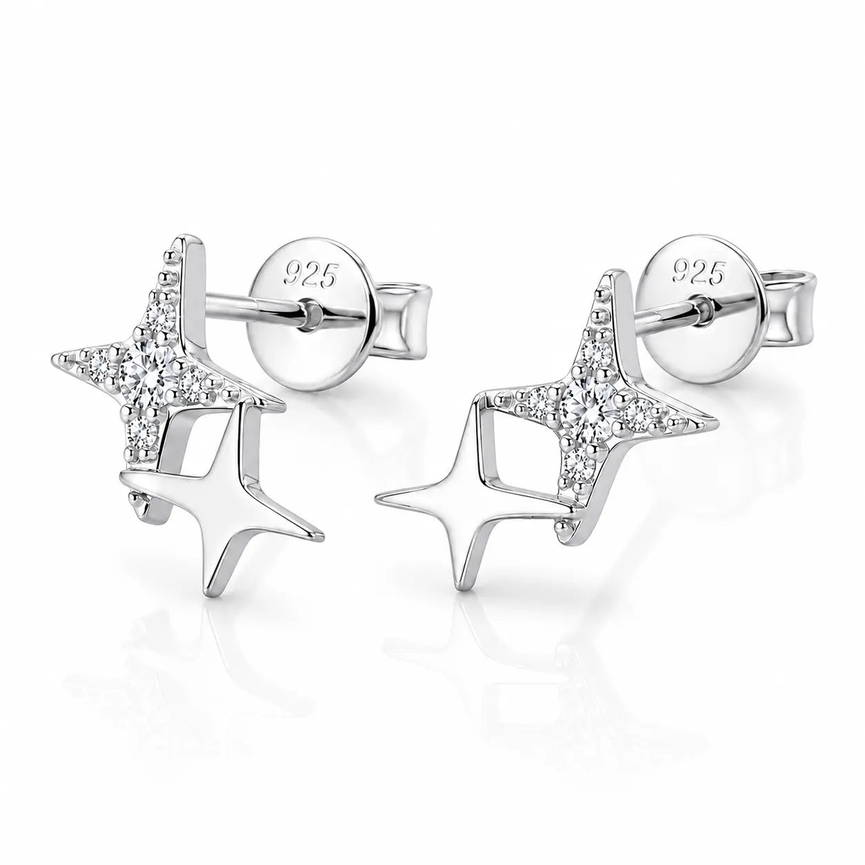 A pair of sterling silver star stud earrings with clear pavé-set stones on one star and a polished silver star on the other, shown on a reflective white background.