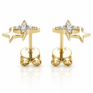 A pair of gold star-shaped stud earrings with clear gemstones, displayed on a clean white background with a soft reflection.