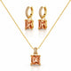 Gold jewelry set featuring a necklace and matching hoop earrings with square peach-colored gemstones and small clear accent stones, displayed on a clean white background.