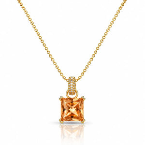 A gold necklace with a princess-cut orange gemstone pendant and a small diamond-accented bail, shown on a clean white background with a soft reflection below.