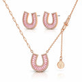 Rose gold jewelry set featuring a horseshoe-shaped pendant necklace, matching stud earrings, and a small clover charm on a delicate chain, displayed on a clean white background.