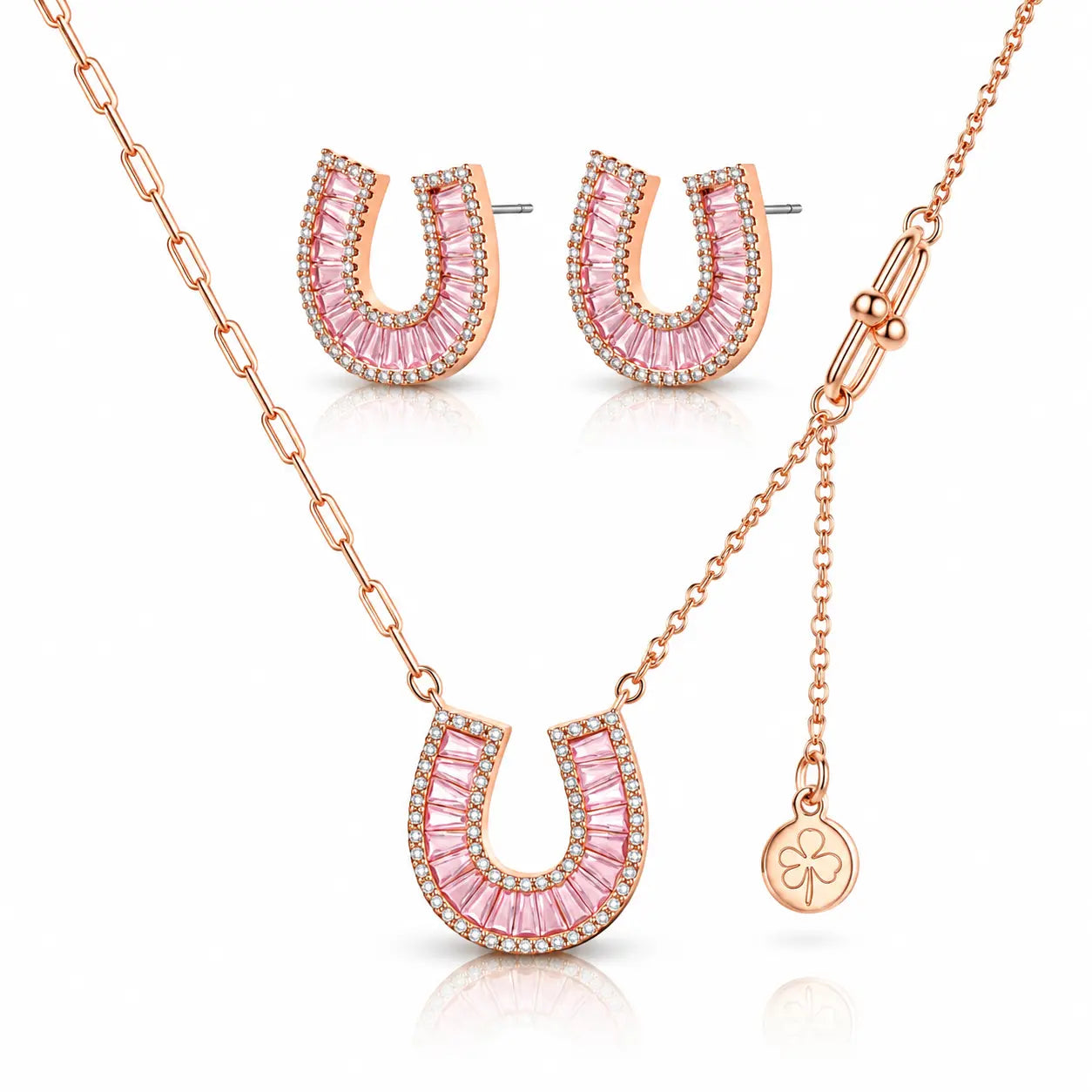 Rose gold jewelry set featuring a horseshoe-shaped pendant necklace, matching stud earrings, and a small clover charm on a delicate chain, displayed on a clean white background.
