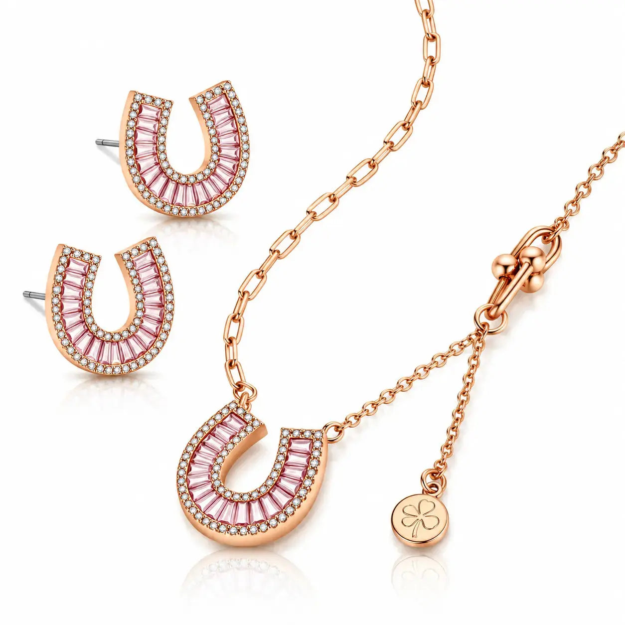 Rose gold jewelry set featuring a horseshoe-shaped pendant necklace, matching stud earrings, and a small clover charm on a white background.
