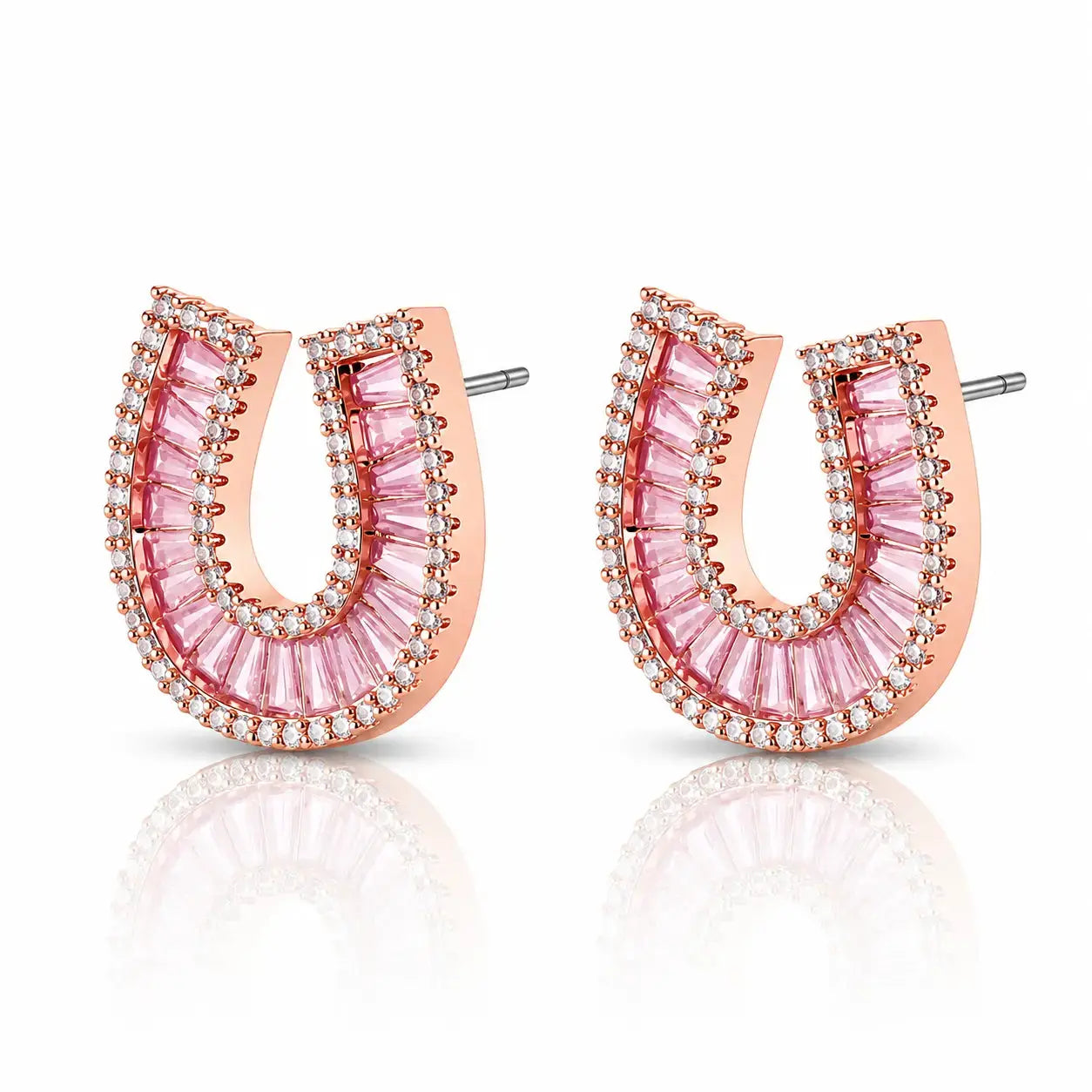 A pair of rose gold horseshoe-shaped stud earrings embellished with pink baguette-cut crystals and small clear stones, shown on a white background with a soft reflection.