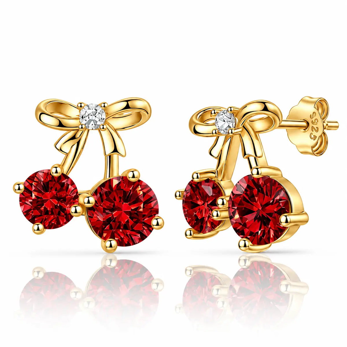 A pair of gold cherry stud earrings with round red gemstones and a small clear stone at the bow center, shown on a white background with reflections.
