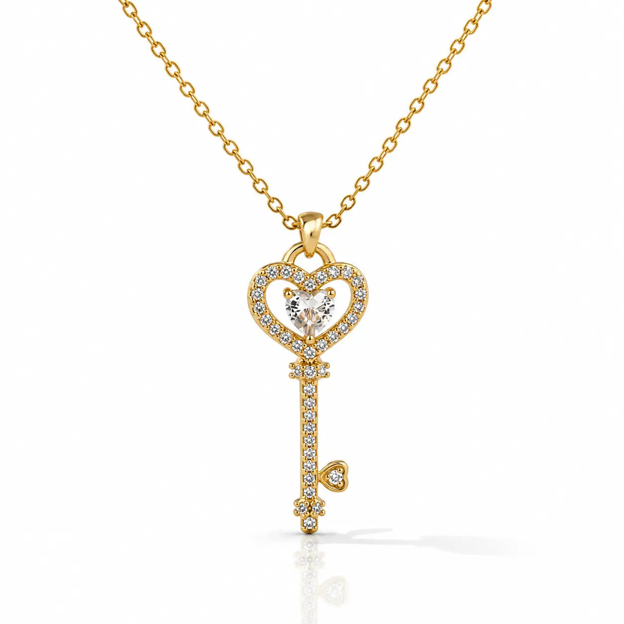 Gold key-shaped pendant necklace with diamonds on a white background
