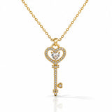 Gold key-shaped pendant necklace with diamonds on a white background