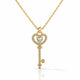 Gold key-shaped pendant necklace with diamonds on a white background