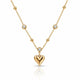 A gold necklace featuring a polished heart-shaped pendant and several small bezel-set clear stones along the chain, displayed on a clean white background with a soft reflection.