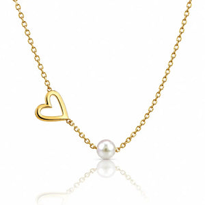 A delicate gold chain necklace featuring an open heart pendant and a single white pearl bead, displayed against a clean white background with a soft reflection below.