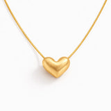 Gold heart-shaped pendant on a white background