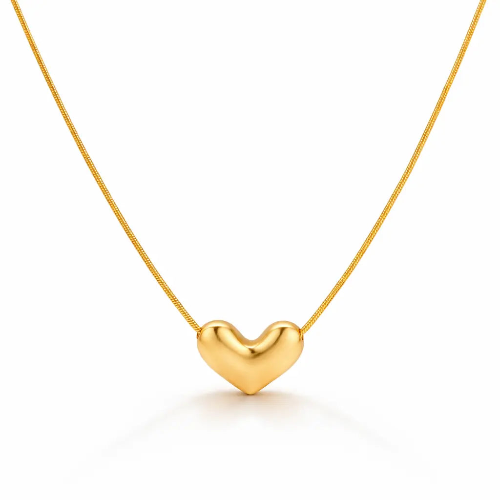Gold heart-shaped pendant on a thin chain against a white background