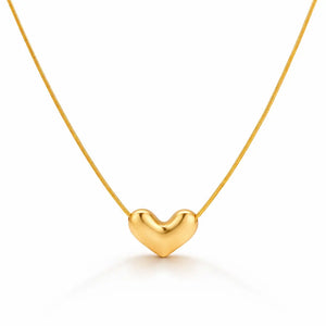 Gold heart-shaped pendant on a thin chain against a white background