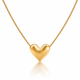 Gold heart-shaped pendant on a chain against a white background