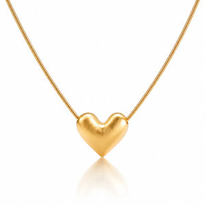 Gold heart-shaped pendant on a chain against a white background