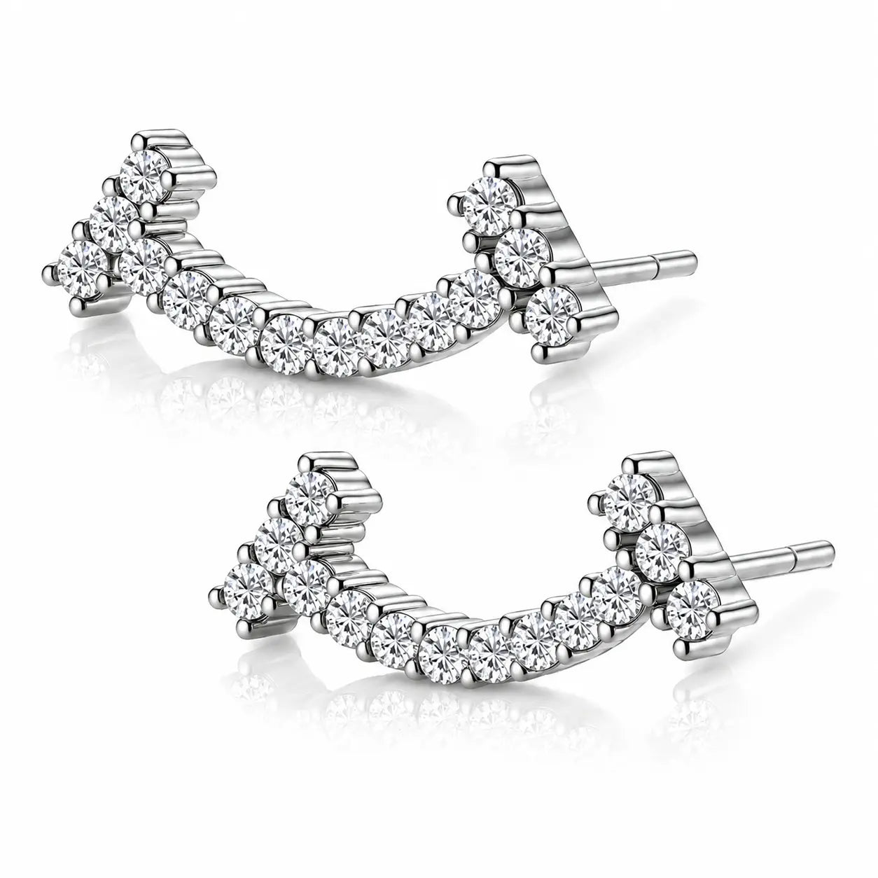 A pair of silver-toned curved stud earrings set with clear round-cut gemstones, displayed on a clean white background with soft reflections.