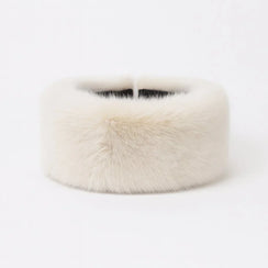 Warm woolen winter hat with fluffy fur pom-pom in soft pastel and classic colors – perfect for autumn and winter.