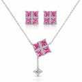 Silver-tone jewelry set featuring a necklace, matching stud earrings, and a small pendant charm. The necklace and earrings have square pink gemstone centers set with clear stones in a cross pattern, with the necklace chain extending to the edges of the frame.