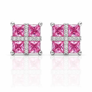 A pair of square stud earrings featuring four bright pink princess-cut stones arranged in a cross pattern with a border of small clear stones, set in silver-toned metal on a white background with a soft reflection.