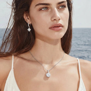 Woman wearing a necklace and earrings with a beach background