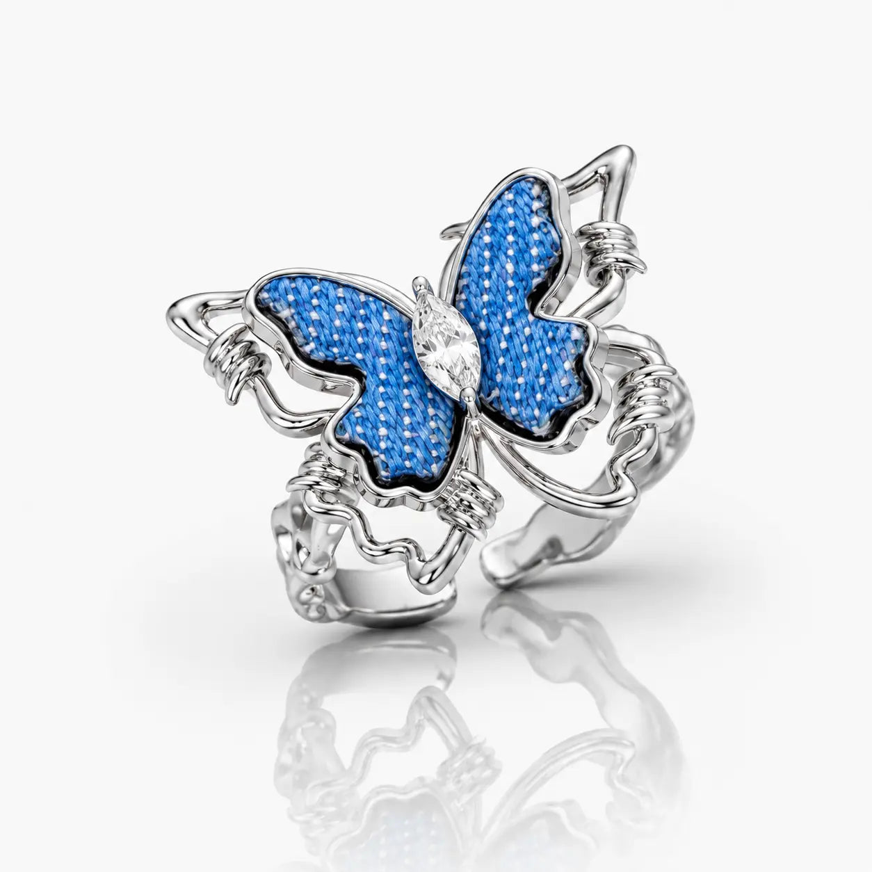 Butterfly-shaped jewelry charm with blue and silver design on a white background