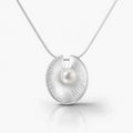Silver pendant with a pearl on a white background