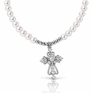 A white pearl necklace with a silver-toned cross pendant adorned with clear crystals, shown on a clean white background with a soft reflection below.