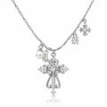 Silver-tone cross pendant necklace with clear rhinestones, a pearl charm, and snowflake charms on a white background.