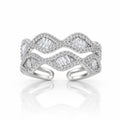 A silver-toned open cuff ring featuring a wavy, layered design paved with small clear stones and accented with larger baguette-cut clear stones, shown on a white background with a soft reflection.