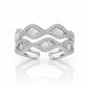 A silver-toned open cuff ring featuring a wavy, layered design paved with small clear stones and accented with larger baguette-cut clear stones, shown on a white background with a soft reflection.