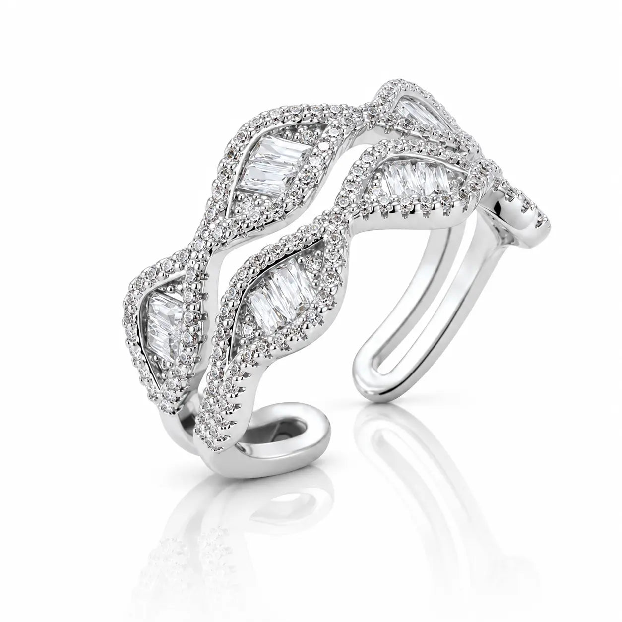 A silver-toned open cuff ring adorned with baguette and round-cut clear stones, shown on a clean white background with a soft reflection below.