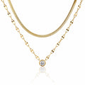 Three gold necklaces with different chains on a white background