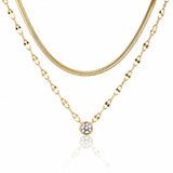 Three gold necklaces with different chains on a white background
