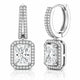 A pair of silver-toned huggie hoop earrings with rectangular princess-cut diamond drops, surrounded by halo and channel settings of small round diamonds, shown on a white background with a subtle reflection.