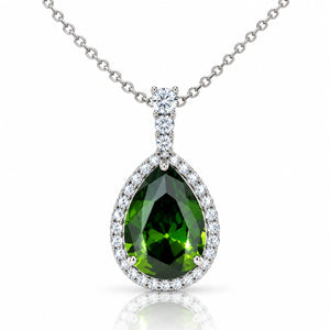 Pear-shaped green gemstone pendant necklace with a silver halo and pavé setting, suspended from a silver chain on a white background.