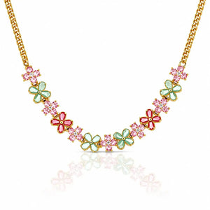 A gold chain necklace featuring a series of colorful flower charms in pink and mint green, displayed on a clean white background with a soft reflection below.