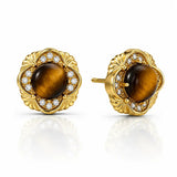 A pair of gold stud earrings featuring round brown tiger's eye centers surrounded by a halo of small clear stones and a scalloped gold setting, shown on a white background with a soft reflection.