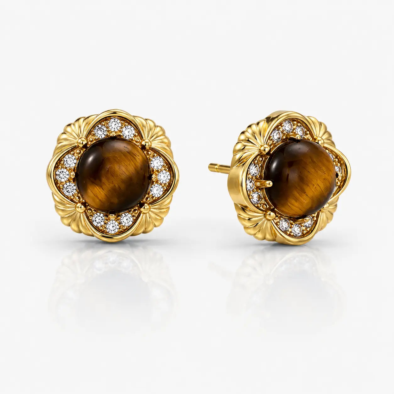 Pair of gold earrings with tiger's eye stones and diamond accents on a white background
