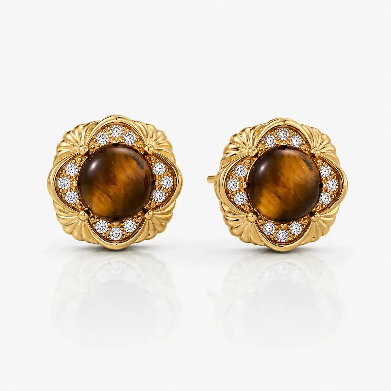 Pair of gold earrings with tiger's eye stones on a white background