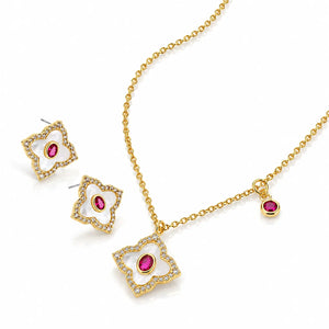 Gold jewelry set featuring a necklace, earrings, and a small charm, each decorated with a four-pointed star-shaped frame paved with clear stones and a central oval pink gemstone.