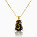 Gold necklace with a black pendant on a white background