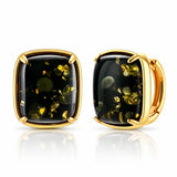 A pair of gold-toned cushion-cut stud earrings with black onyx-like centers containing metallic gold flecks, shown on a clean white background with a soft reflection.