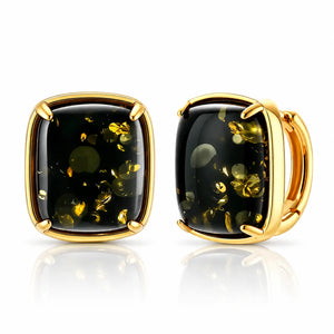 A pair of gold-toned cushion-cut stud earrings with black onyx-like centers containing metallic gold flecks, shown on a clean white background with a soft reflection.