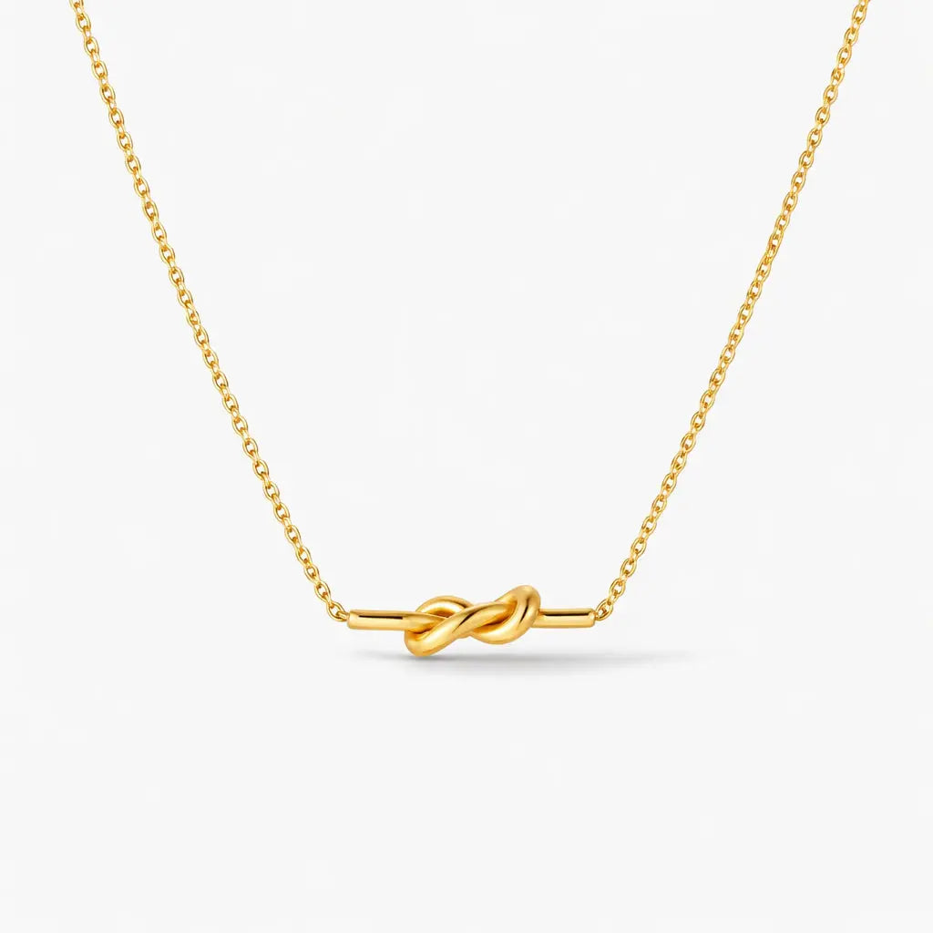 18K gold plated knot necklace with delicate chain on white background