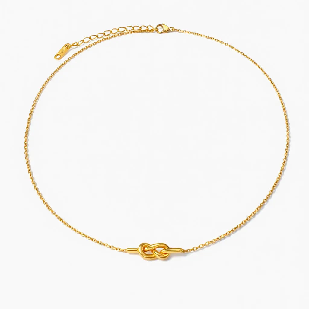 18K gold plated knot necklace with fine chain on white background