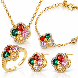 Gold-tone jewelry set with a flower cluster design featuring red, green, pink, and yellow gemstones, shown as a necklace, bracelet, ring, and matching stud earrings on a white background.